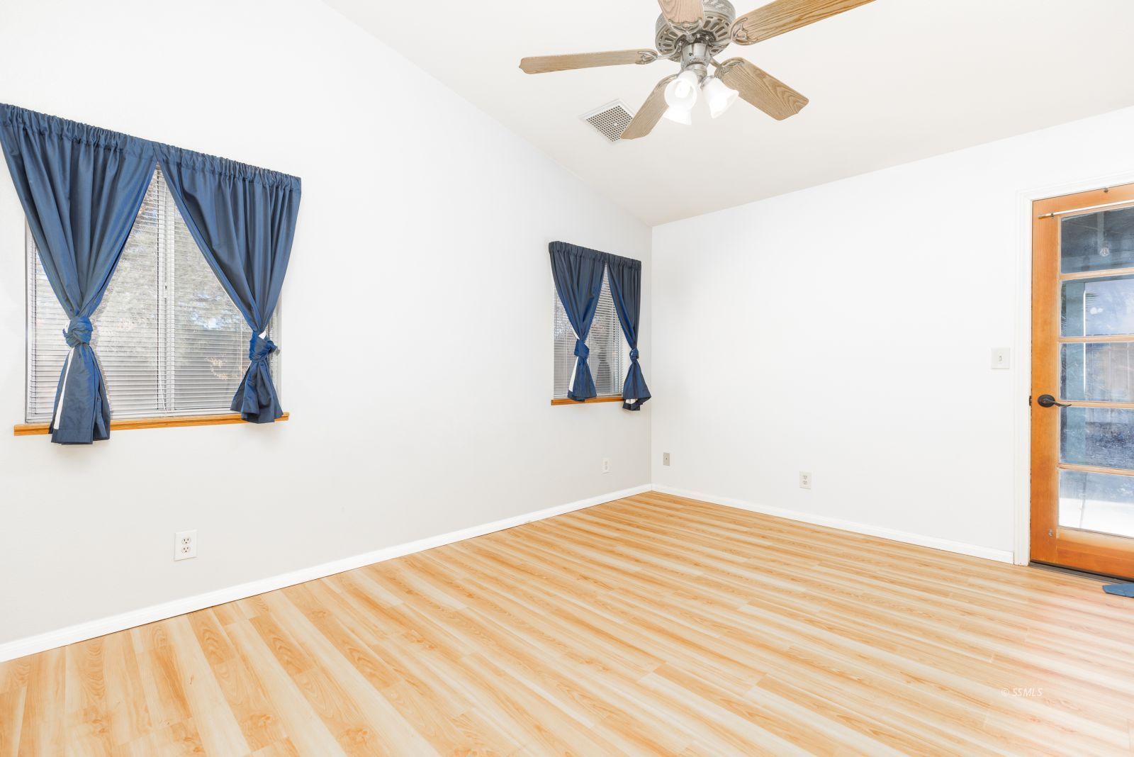 528 Amanda Street Ridgecrest, CA 93555 - Photo 15 of 30 a view of a bedroom with wooden floor and ceiling fan