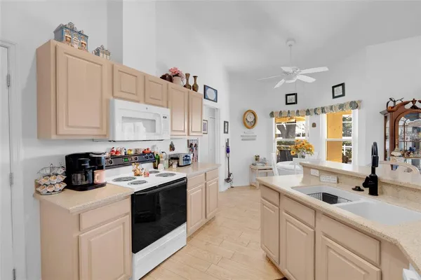 a kitchen with a sink cabinets and window