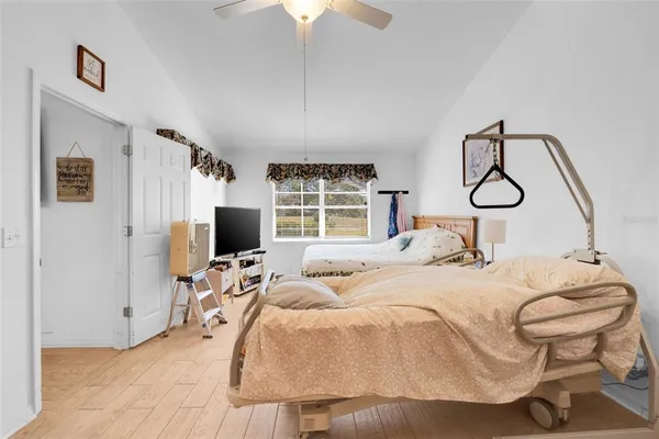 a bedroom with two beds and a window