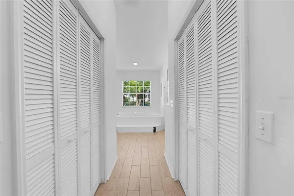 a spacious bathroom with a tub double sink and mirror