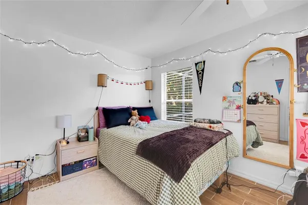 a bedroom with a bed furniture and a flat screen tv