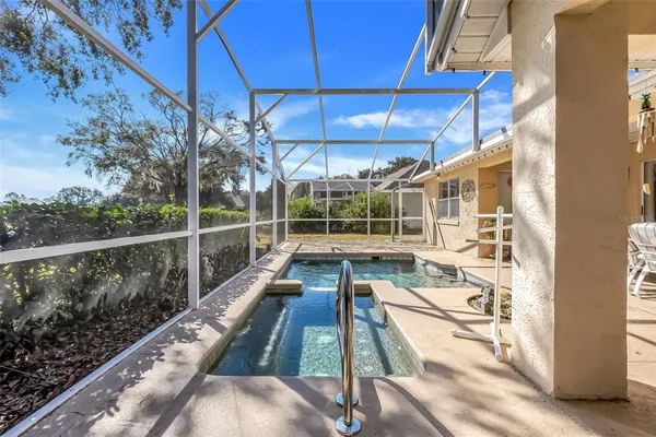 a view of a house with a backyard and a tub