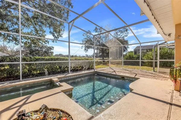 a view of a house with swimming pool and sitting area