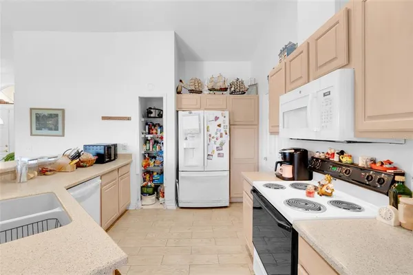 a kitchen with stainless steel appliances a sink stove and cabinets