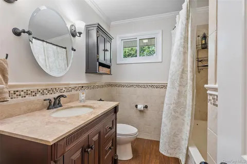 a bathroom with a sink a toilet and a mirror