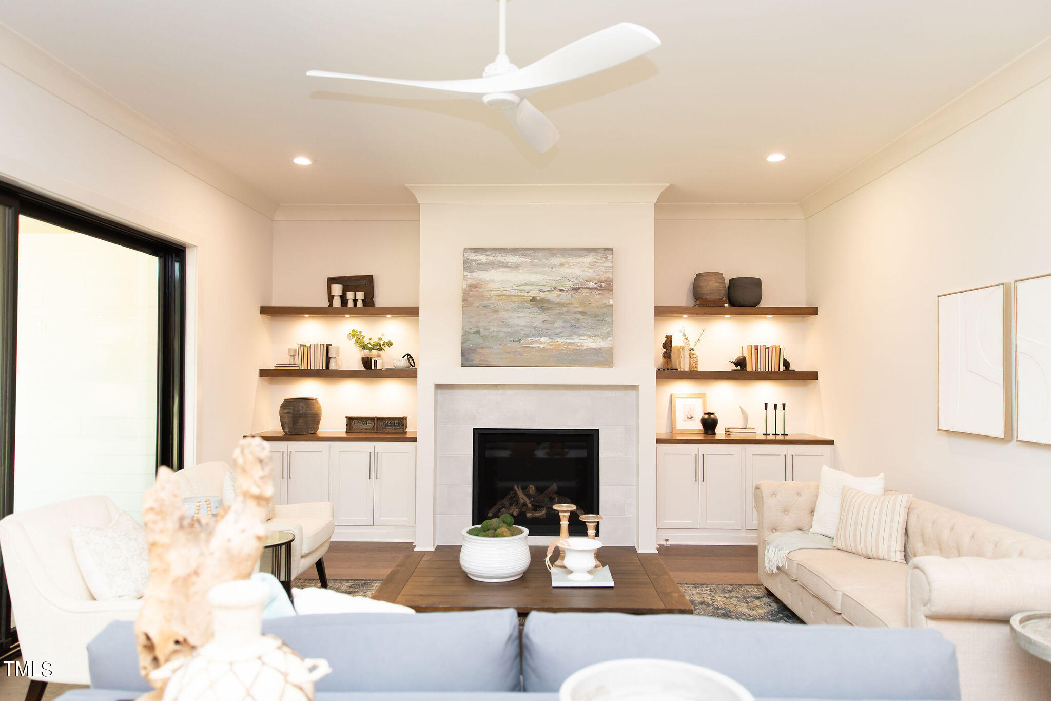 9412 Rawson Avenue Raleigh, NC 27613 - Photo 14 of 53 a living room with furniture a fireplace and a large window