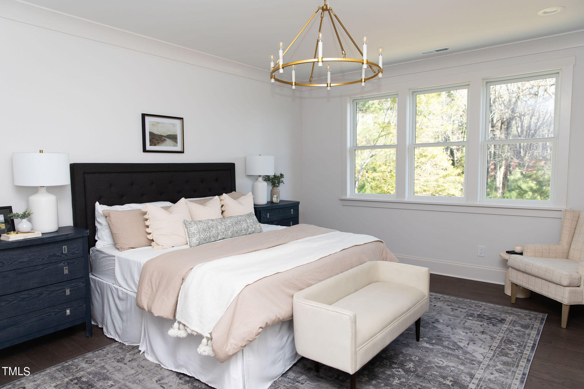 9412 Rawson Avenue Raleigh, NC 27613 - Photo 19 of 53 a bedroom with a bed and a chandelier