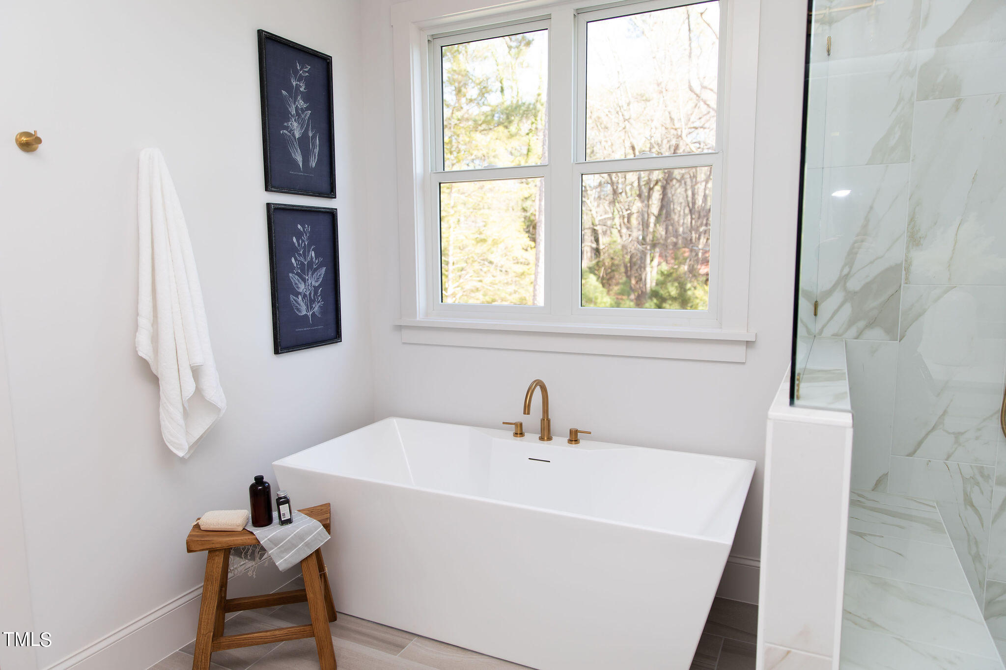 9412 Rawson Avenue Raleigh, NC 27613 - Photo 25 of 53 a white bath tub sitting next to a window