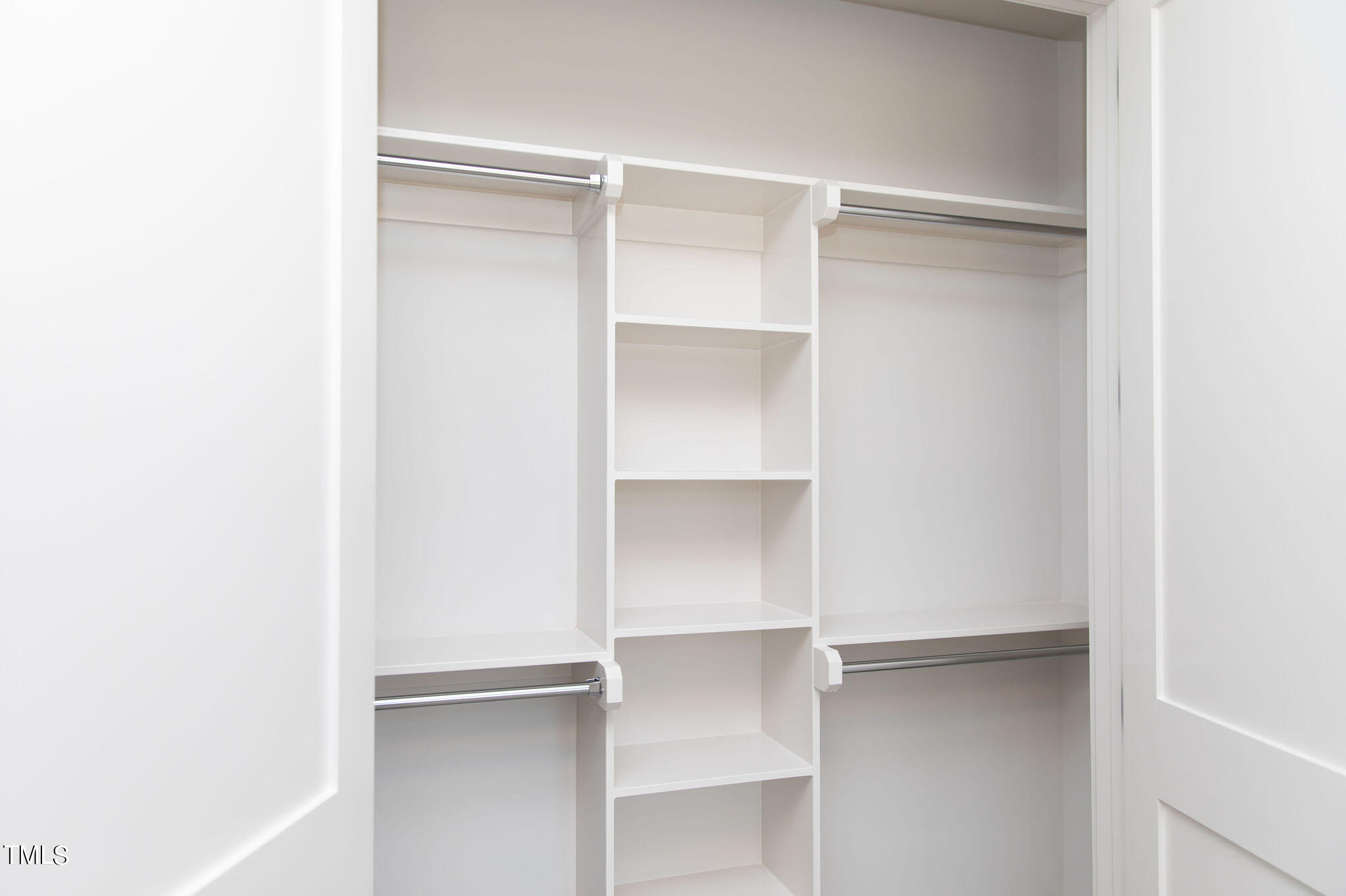 9412 Rawson Avenue Raleigh, NC 27613 - Photo 37 of 53 a view of walk in closet with empty racks