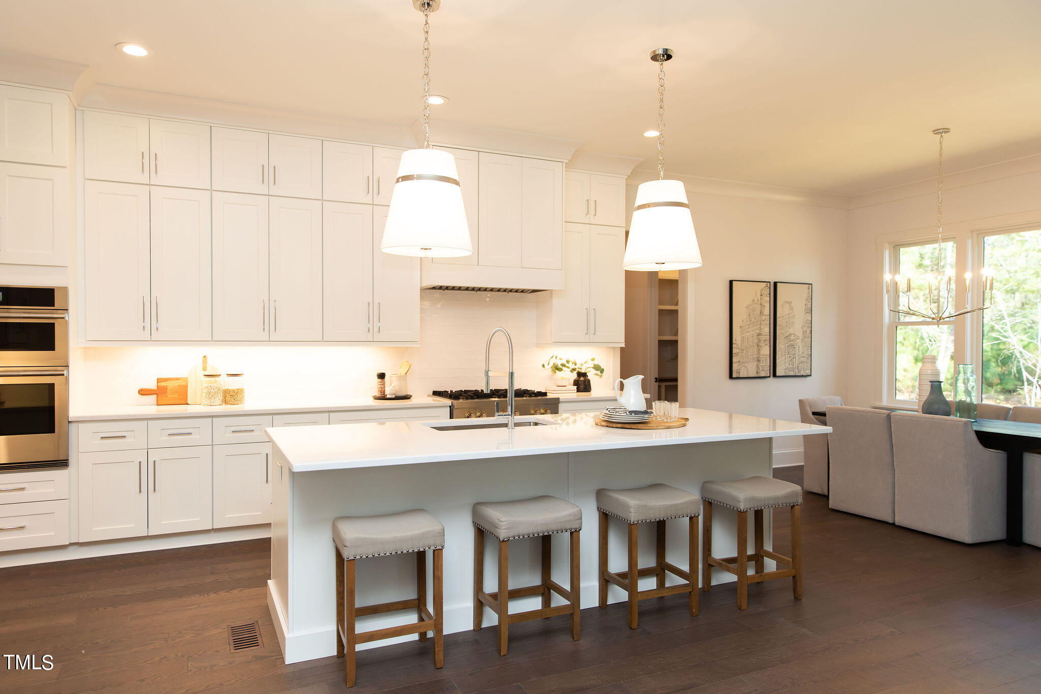 9412 Rawson Avenue Raleigh, NC 27613 - Photo 5 of 53 a kitchen with kitchen island granite countertop a sink a stove a dining table and chairs