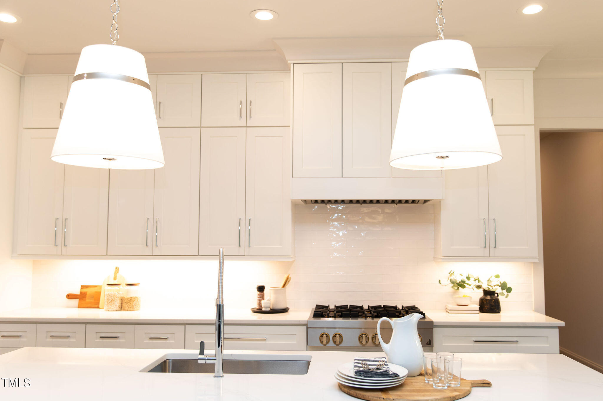 9412 Rawson Avenue Raleigh, NC 27613 - Photo 6 of 53 a kitchen with a sink and a stove