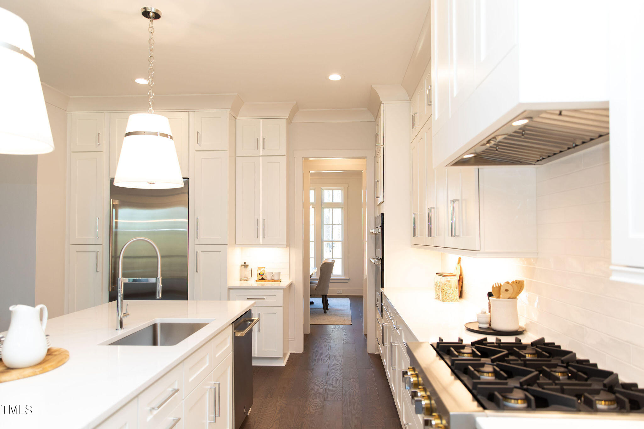 9412 Rawson Avenue Raleigh, NC 27613 - Photo 7 of 53 a kitchen with a sink a stove and cabinets
