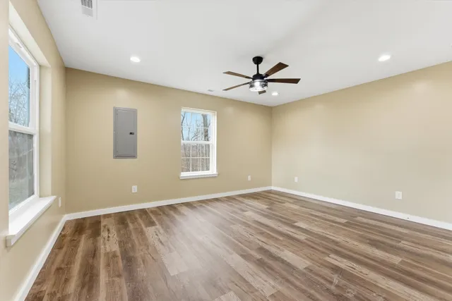 wooden floor in an empty room with a window
