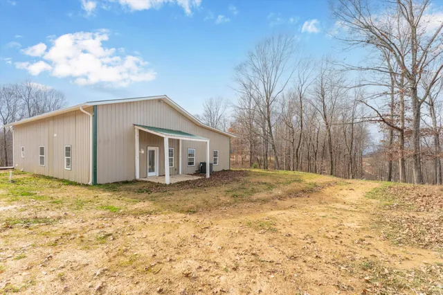 a view of a house with a backyard