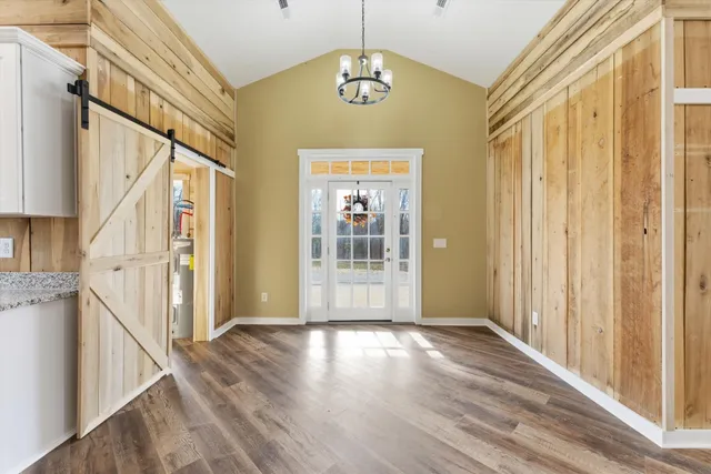 a view of a hallway with wooden floor and staircase