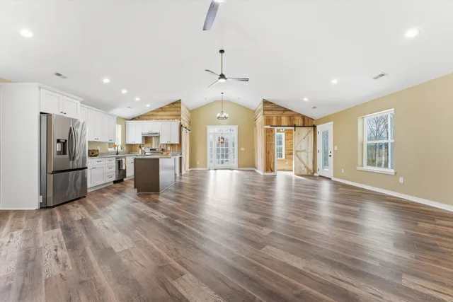 a view of a kitchen with a sink and a refrigerator