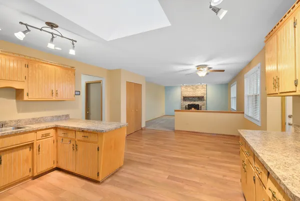 a large white kitchen with cabinets