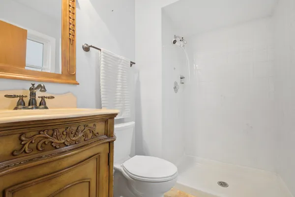 a bathroom with a sink a toilet and shower