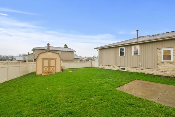 a view of a house with a yard and a garage
