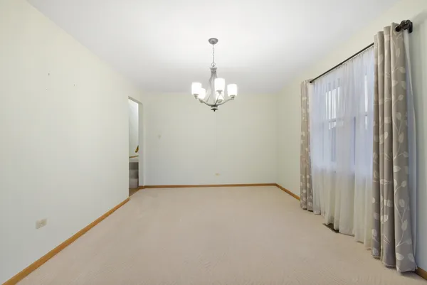 a view of a chandelier in big room and chandelier fan