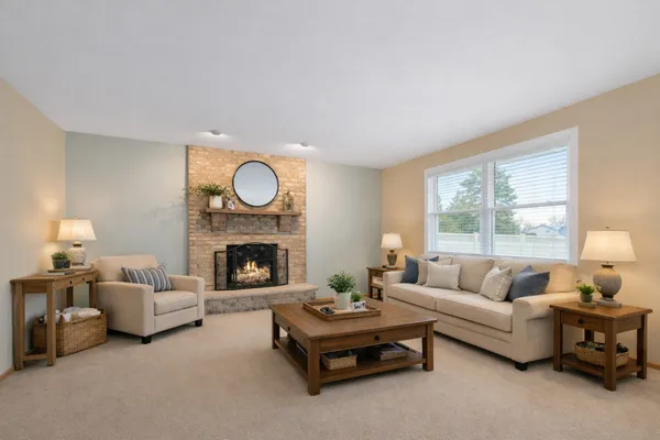 a living room with furniture and a fireplace