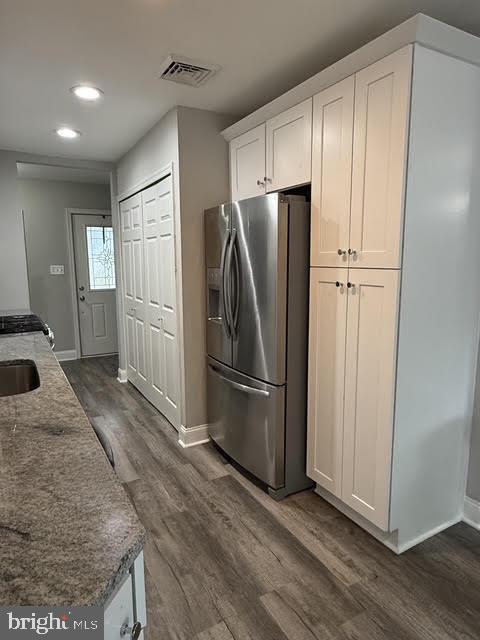 802 Devon Road Riverside, NJ 08075 - Photo 27 of 29 a kitchen with stainless steel appliances granite countertop a refrigerator a sink a stove and white cabinets with wooden floor