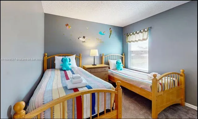 a bedroom with two beds and a window