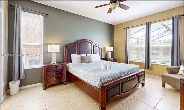 a spacious bedroom with a bed and a chandelier