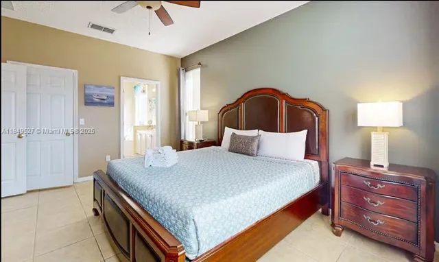 a bedroom with a bed and a mirror on dresser