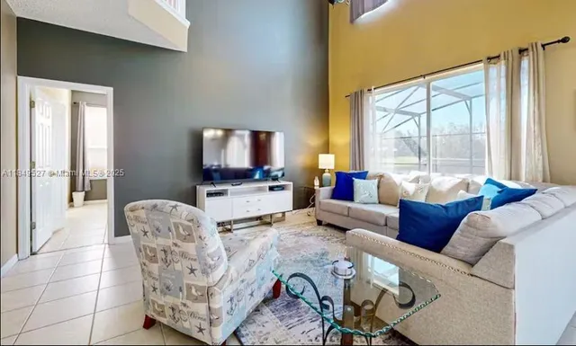 a living room with furniture and a large window