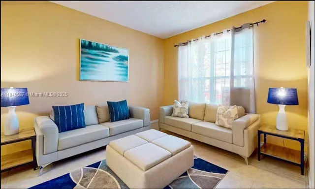 a living room with furniture and a window
