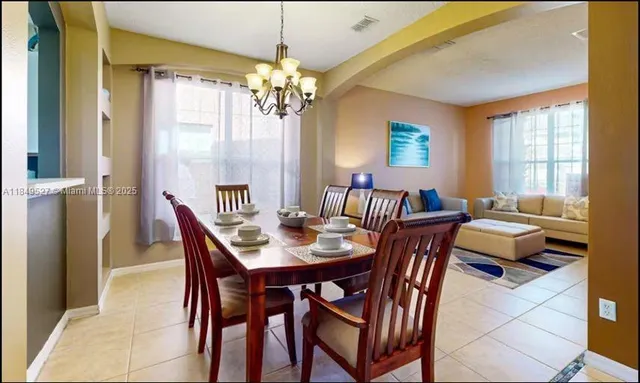 a view of a dining room with furniture and chandelier