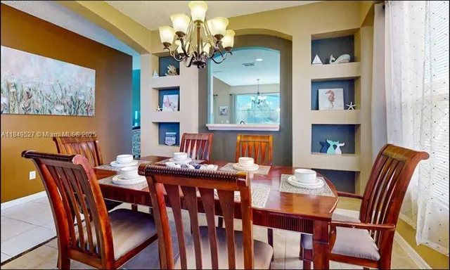 a view of a dining room with furniture wooden floor and chandelier