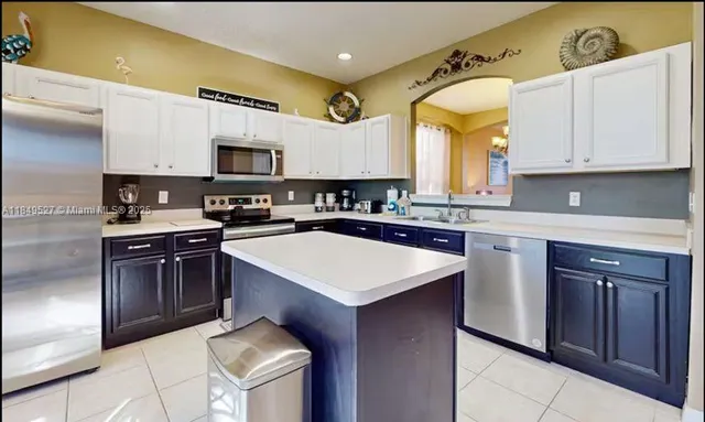 a kitchen with a sink stove top oven and microwave