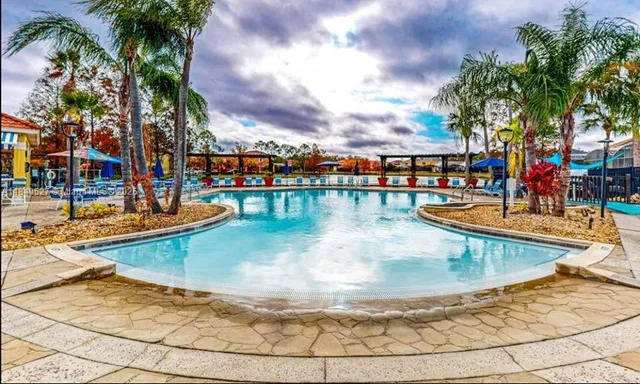 a view of a swimming pool with an outdoor seating