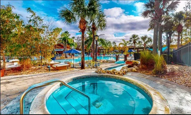 a view of a swimming pool with sitting area