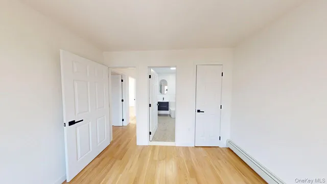 a view of a room with wooden floor and entryway