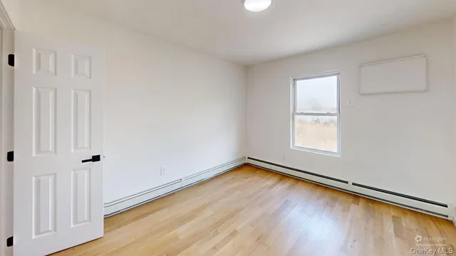 a view of a room with wooden floor and window