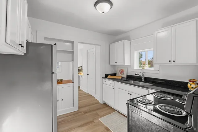 a kitchen with stainless steel appliances granite countertop a stove and a refrigerator