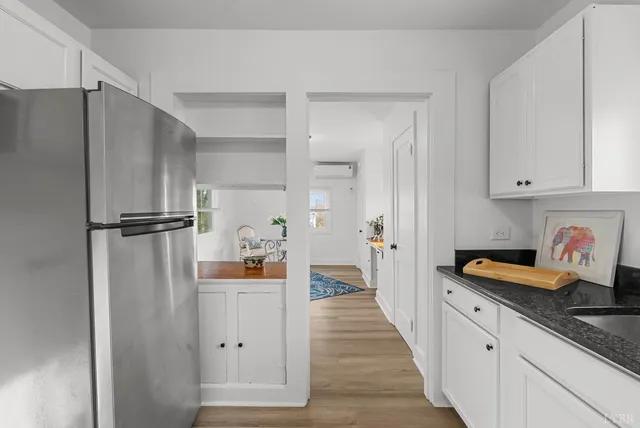 a kitchen with stainless steel appliances granite countertop a refrigerator and a sink