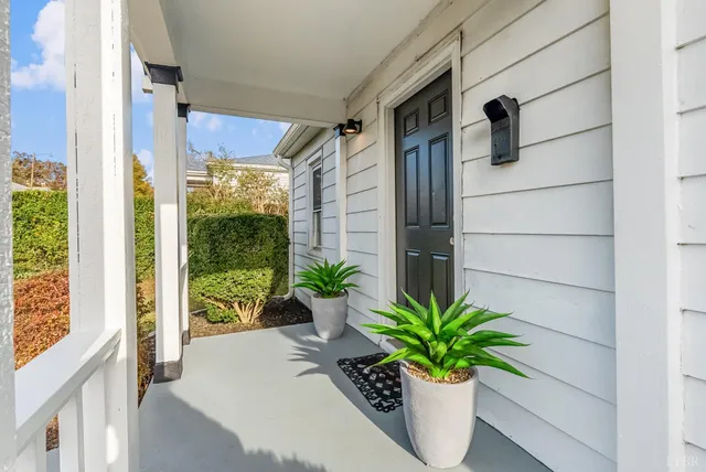 a flower pot with a potted plant on a window