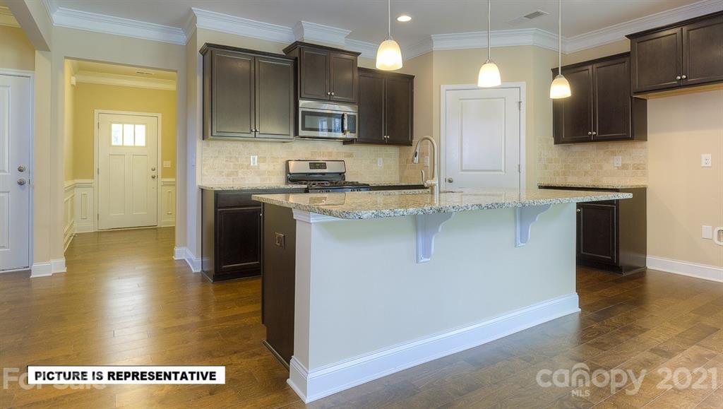 4366 Riverton Loop Denver, NC 28037 - Photo 6 of 14 a kitchen with stainless steel appliances granite countertop a stove a sink and a refrigerator