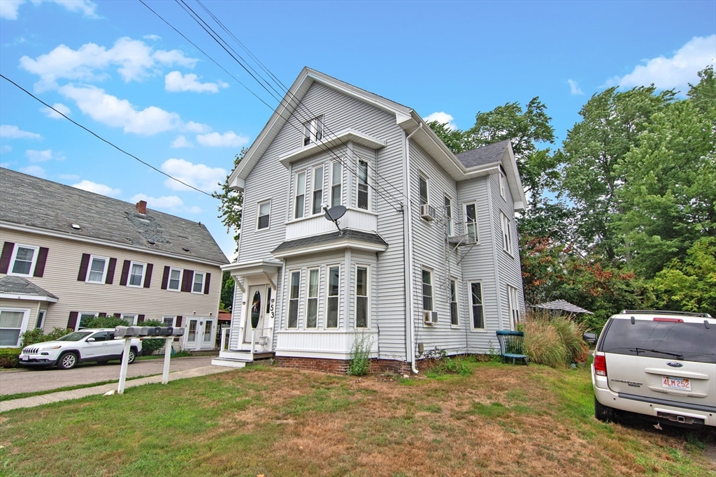53 Temple Street Whitman, MA 02382 - Photo 2 of 14 a view of a white house with a big yard and large trees