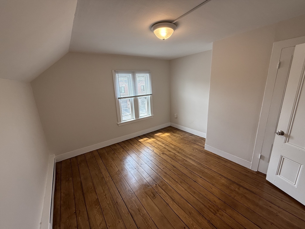 53 Temple Street Whitman, MA 02382 - Photo 8 of 14 an empty room with wooden floor and windows