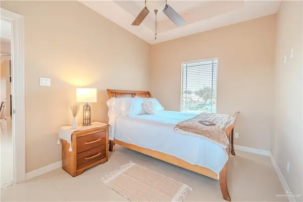 a bedroom with a bed and a mirror