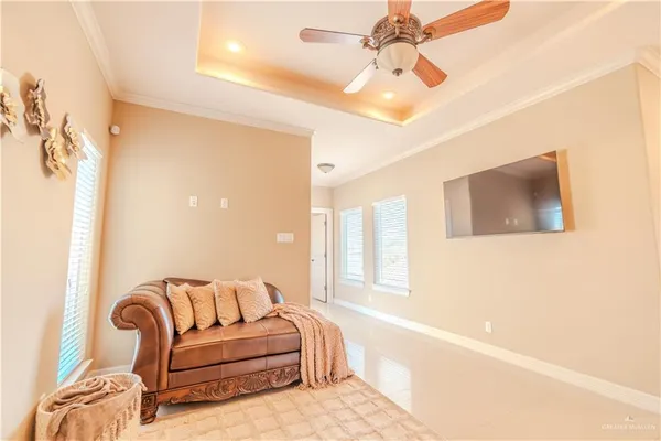 a living room with furniture a flat screen tv and a window