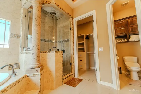 a bathroom with a tub sink and mirror