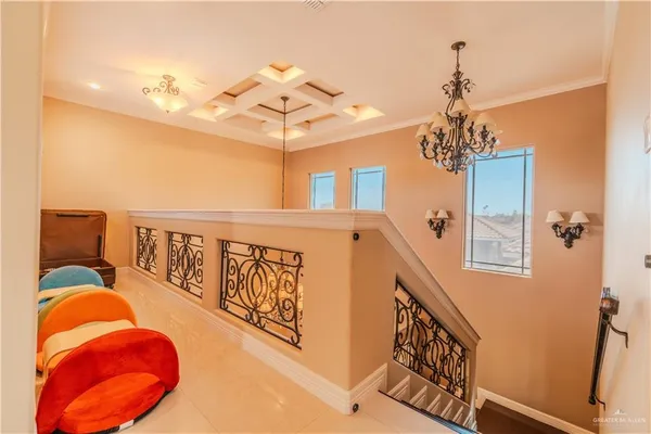 a living room with furniture a rug and a chandelier