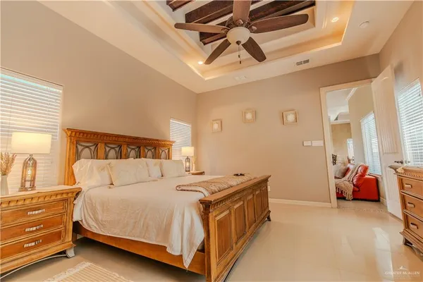 a bedroom with a bed and a chandelier