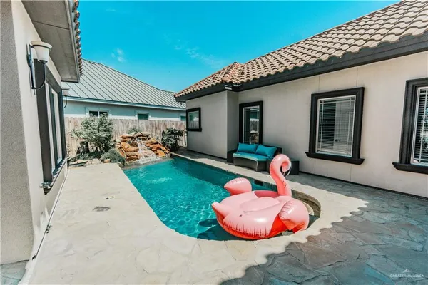 a backyard of a house with table and chairs